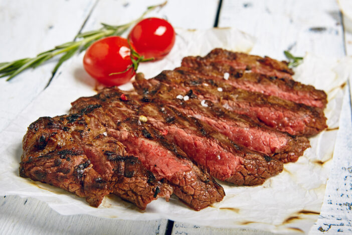 Gourmet Grill Restaurant Beef Steak Menu - Flank Steak on Wooden Background. Beef Steak Dinner