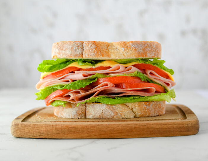 Ham and Cheese Sandwich in white bread with tomato and lettuce