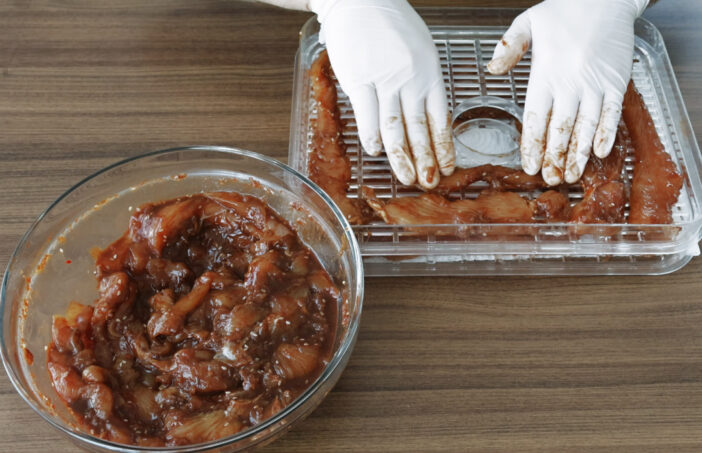 Home cooking Chicken slices while dehydrating making jerky in Dehydrator.