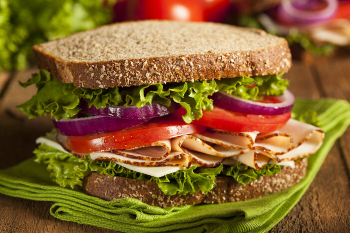 Homemade Turkey Sandwich with Lettuce, Tomato, and Onion