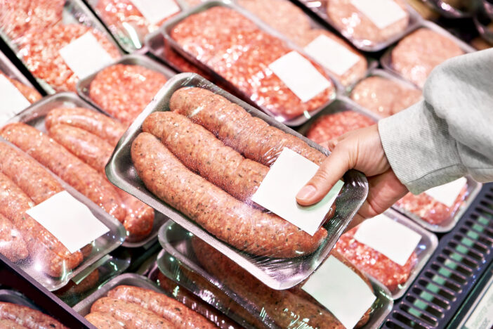 Meat sausages for grilling in the package in store