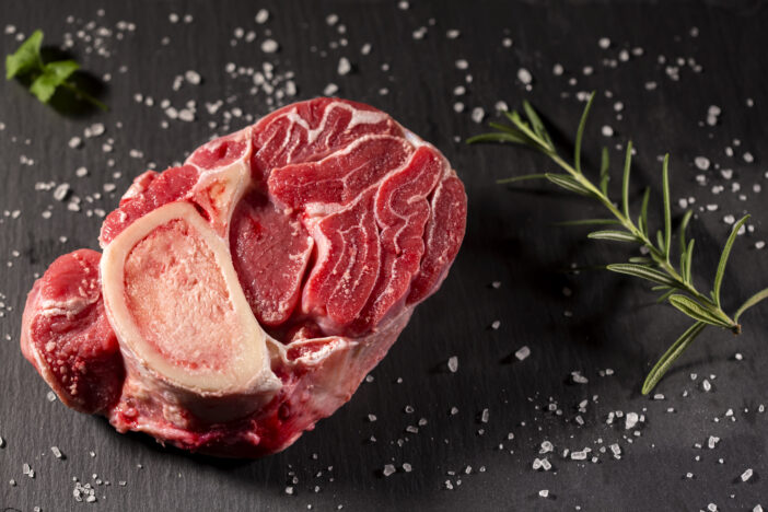 Piece of raw fresh beef shank, lower part of cow's foreleg with herbs