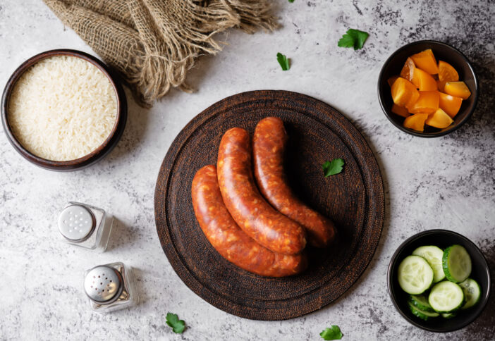 Raw uncooked sausages Chorizo in a plate. tinting. selective focus