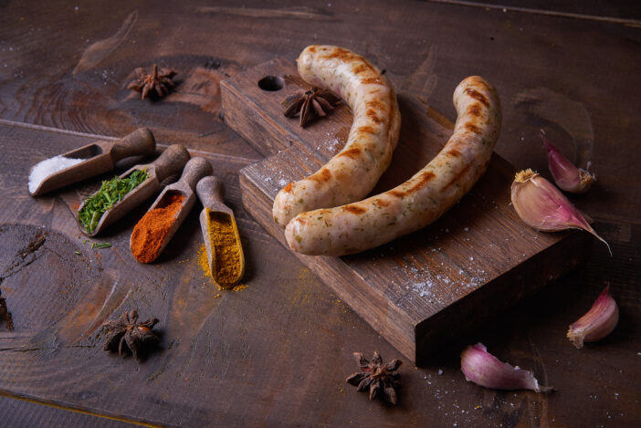 Sausages grilled food background, wood background. View from above. Studio photography, Subject photography.