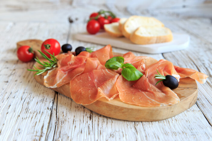 Serrano ham on wooden board