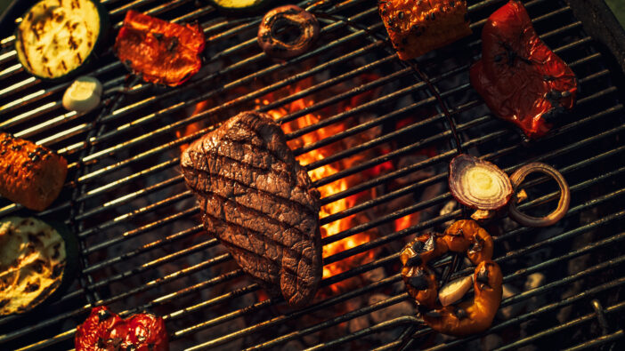 Sizzling Steak and Colorful Vegetables Grill Over Open Flames, Capturing the Essence of Outdoor Cooking, Smoky Flavors, and Culinary Delight in Vibrant Barbecue Setting.