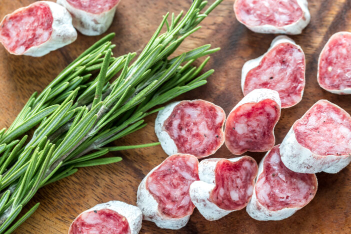 Slices of spanish salami on the wooden board