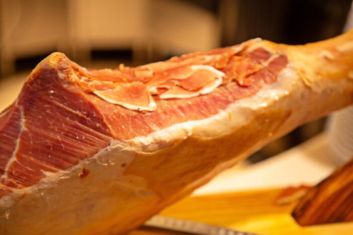 Tasty and delicious delicatessen, whole leg of Spanish Jamon Iberico Ham made from Black Iberian pig. Italian Prosciutto Crudo or Parma ham. Perfect appetizer, party snack or good accompany with wine