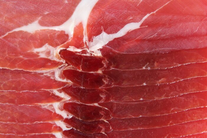 Close up slices Spanish ham or jamón texture. photo