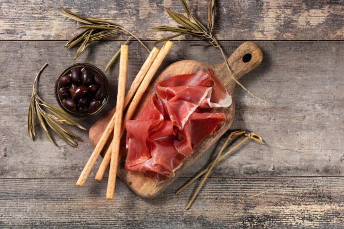 Spanish serrano ham on wooden table