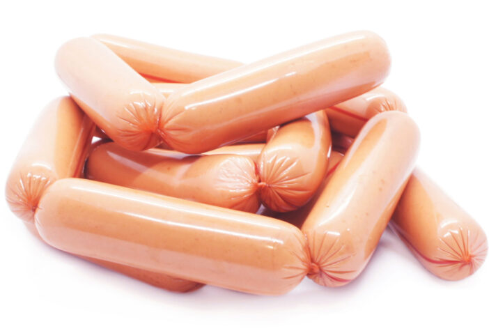 Pile of  sausages isolated on white background. long wieners in artificial casings. side view.