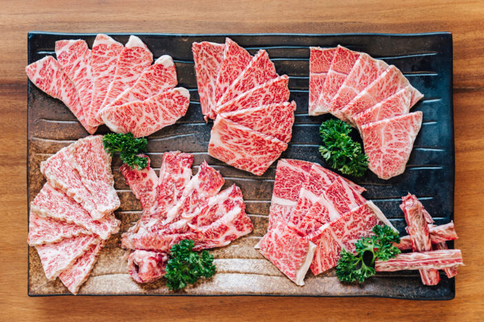 Top view of Premium Rare Slices many parts of Wagyu A5 beef with high-marbled texture on stone plate served for Yakiniku (Grilled Meat).