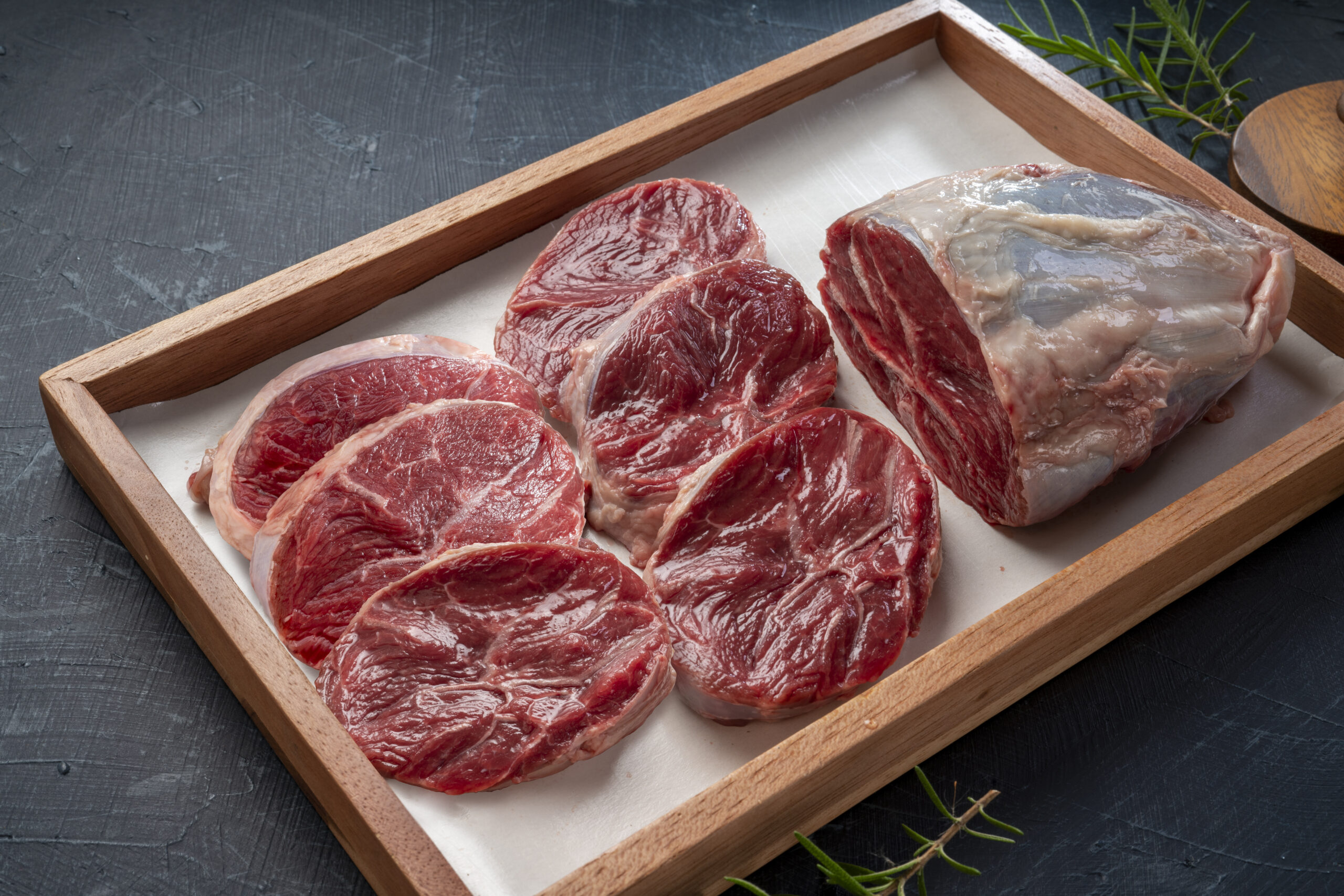 Fresh Silver shank meat in wooden plate on wooden background, Shank beef first grade in wooden plate on wooden background.