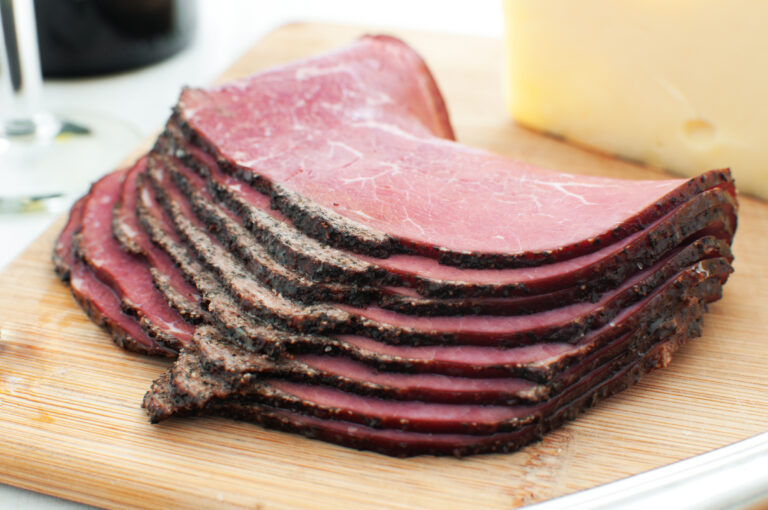 Deli pastrami meat sliced on cutting board horizontal