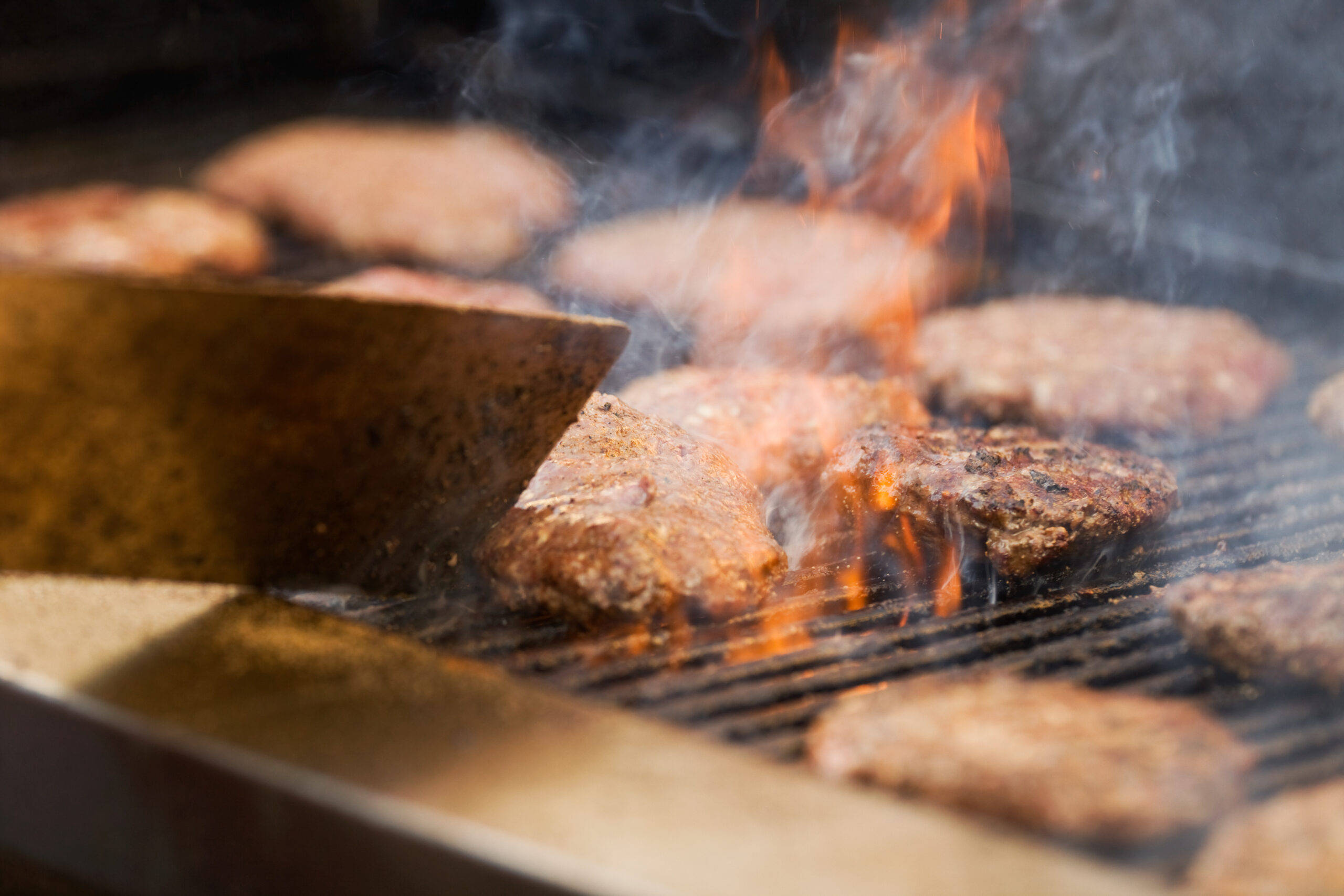 Flame Grilled Hamburgers Cooking on Gas Charbroiler