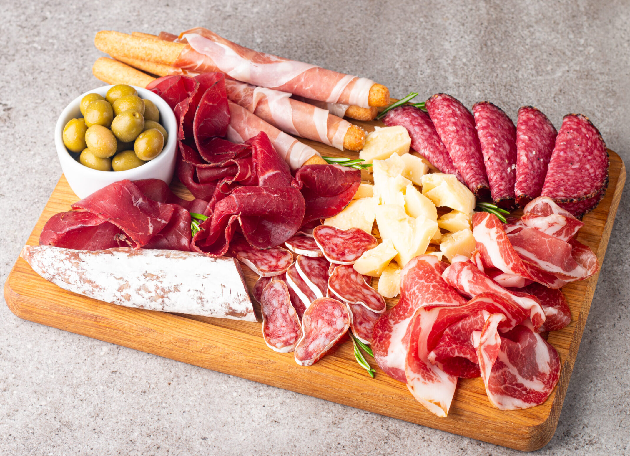 Charcuterie board. Antipasti appetizers of meat and cheese platter with salami, prosciutto crudo or jamon and olives