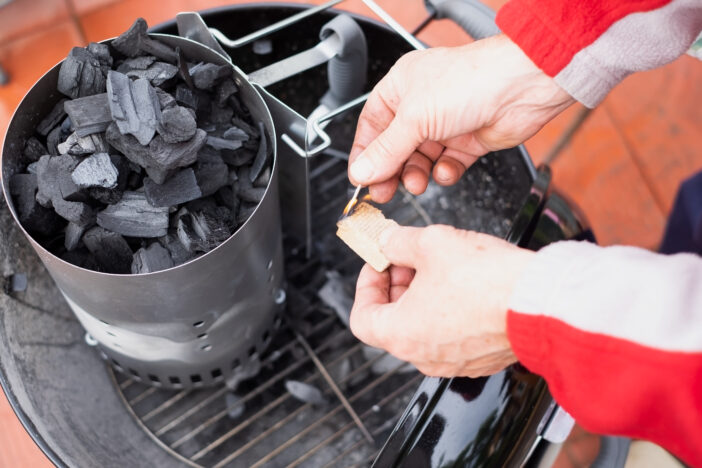 Special charbon or coal for barbecue cooking. Get ready for making fire. Man making fire