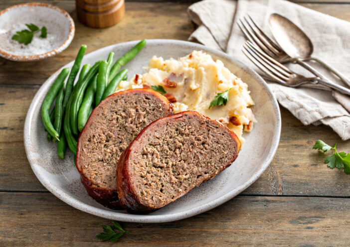 Meatloaf with mashed potatoes and green beans, traditional dinner meal, serving on a plate