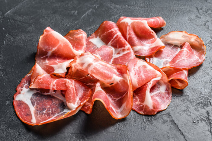 Coppa, Capocollo, Capicollo meat.  Black background. Top view.