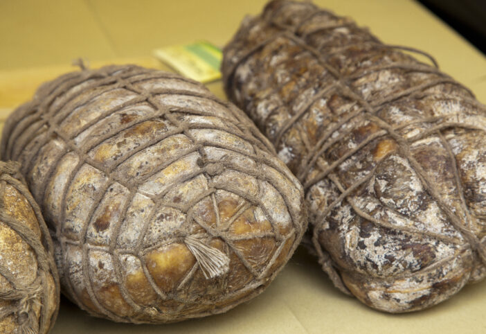 culatello di Zibello, typical italian handmade sausagetypical italian food, fried stuffed olives on paper