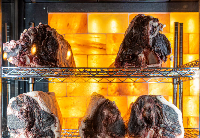 Beef hung and lined up in a dry aged beef cabinet