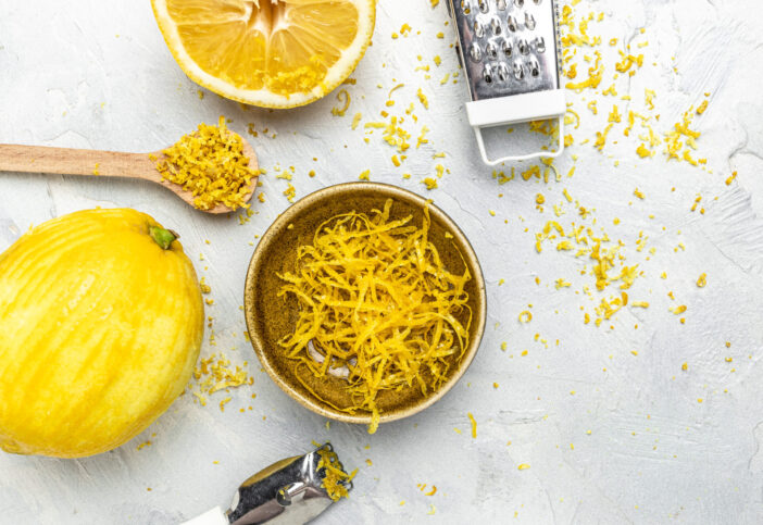 grating lemon zest Ready to Cook, Grater peel and lemon zest on light background, banner, menu, recipe, top view.