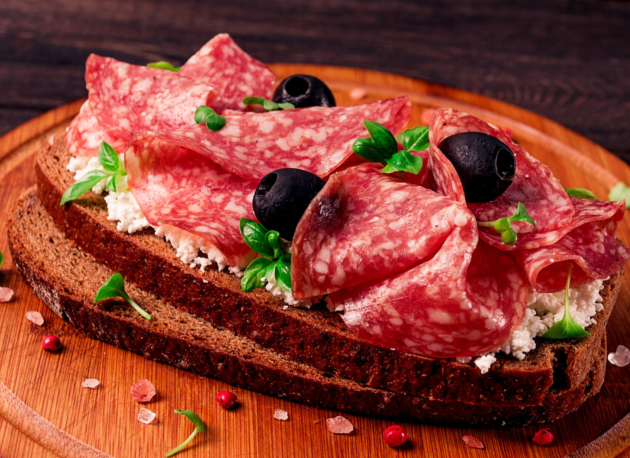 Sandwich , grain bread, with cream cheese and salami, black olives, micro-greens, top view, close-up, no people, Breakfast,