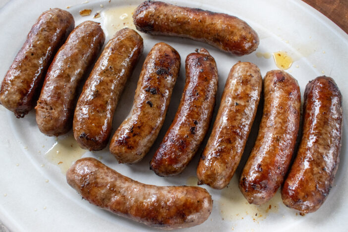 large plate of fried golden brown Italian sausages