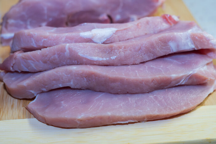 Lean pork - leg prepared for cooking coated steaks.