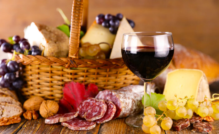 red wine glass with cheese and salami