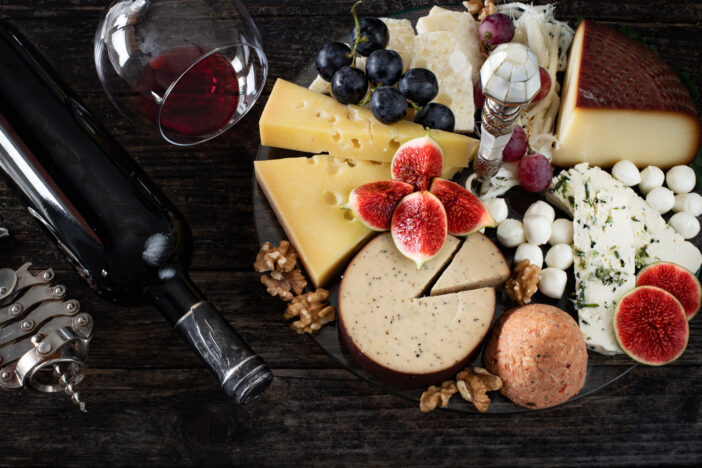 Wine concept with cheese board, fig and grapes.
