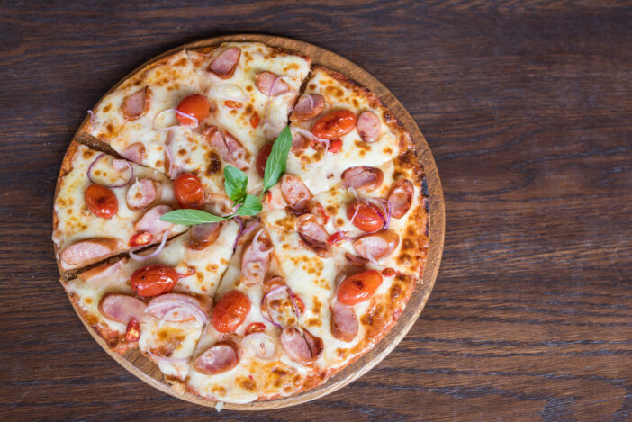 spicy sausage pizza on wooden table, Top view