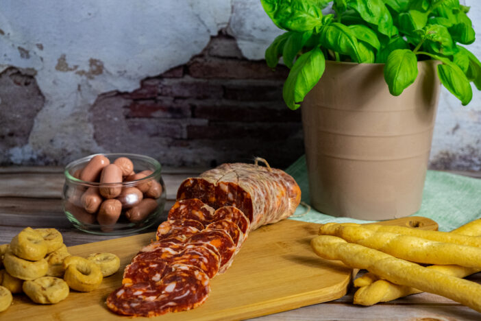 A board of tipycal italian breads and salami.