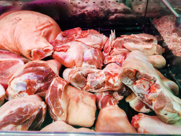 Assorted Fresh Pork Cuts Displayed in Butcher Shop