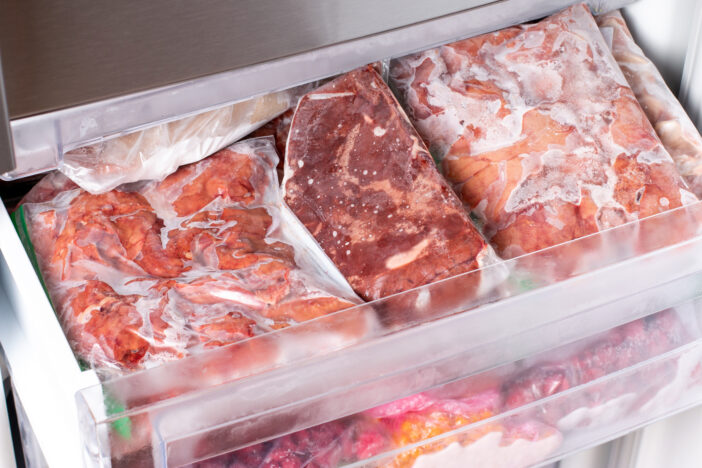 Freezer Filled with Meat and meat frozen products. Meat Frozen in Plastic Bags Food Reserve Stored for Food Preparation. Frozen food