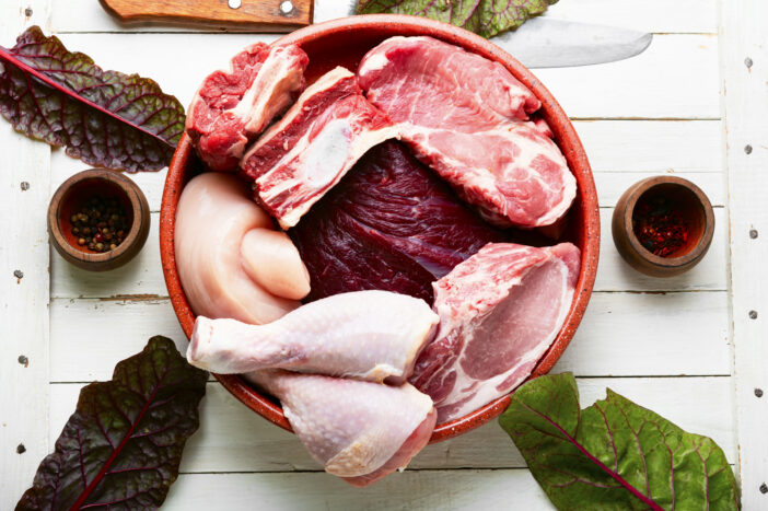 Set of fresh raw meat. Beef, pork and chicken meat on the kitchen table.