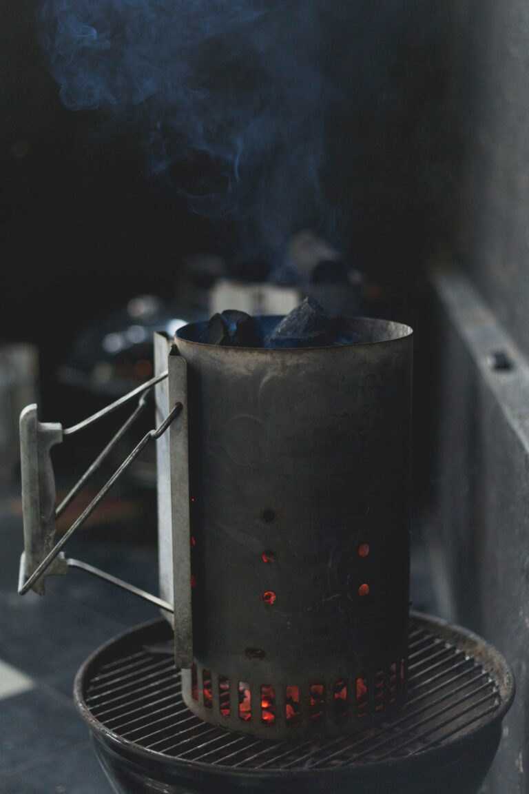 A charcoal chimney on a grill