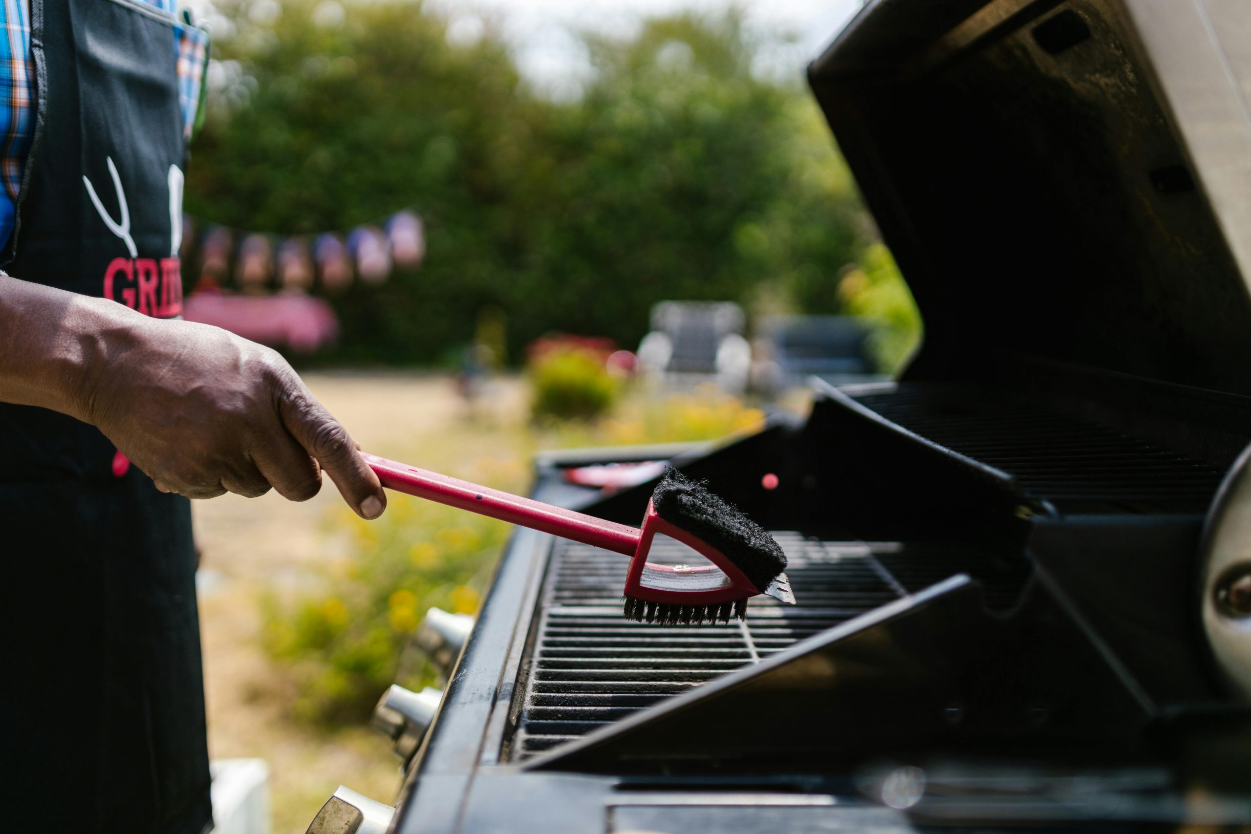 Person cleaning the griller