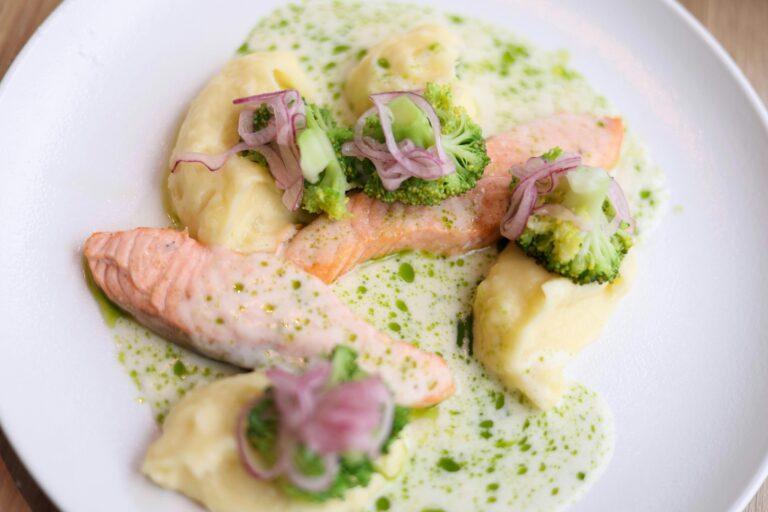 Close up of salmon in sauce with broccoli