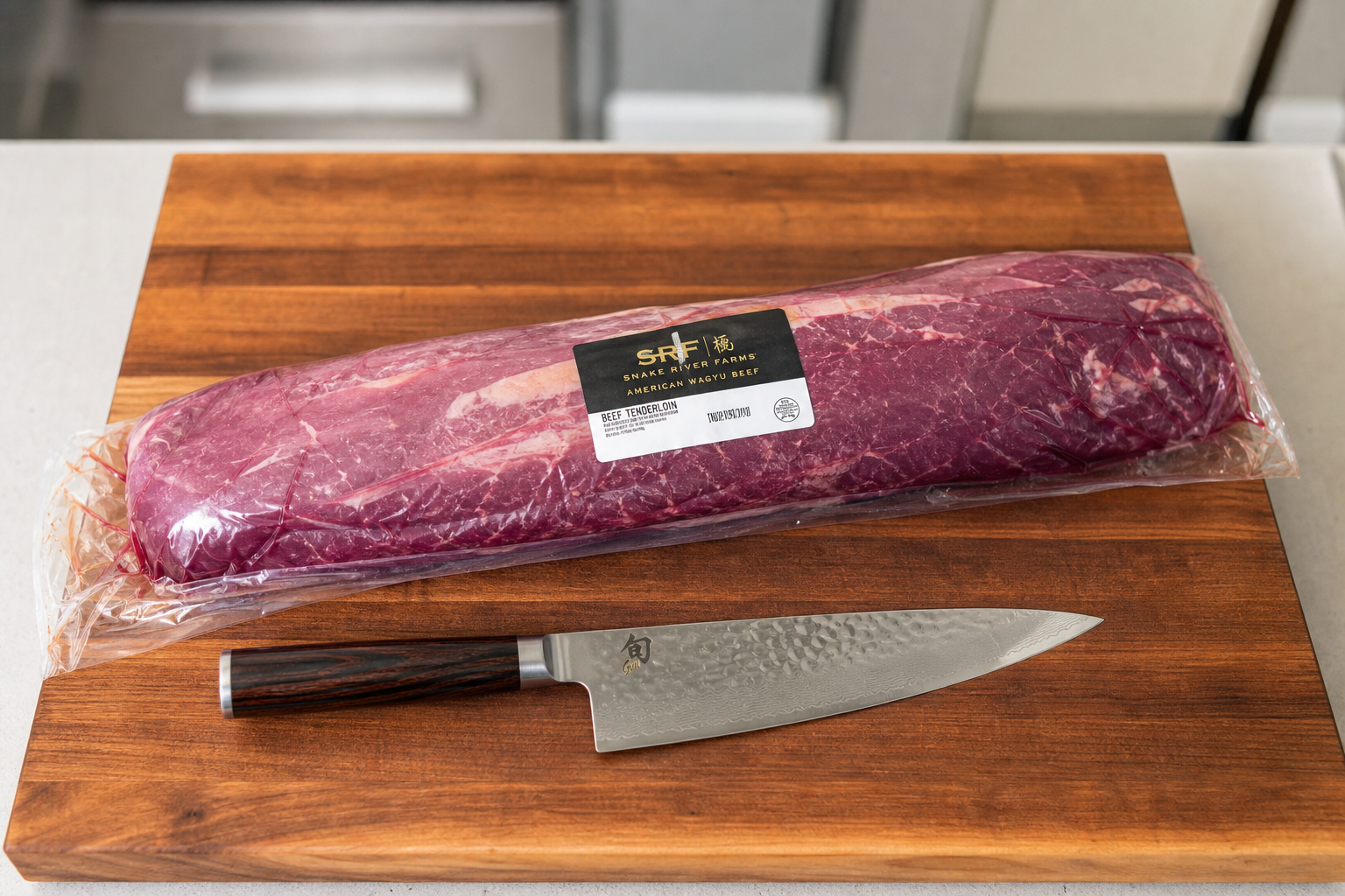How to Save Money Buying Meat at Warehouse Clubs 5 Whole vacuum-sealed beef sub-primal cut on wooden cutting board with knife