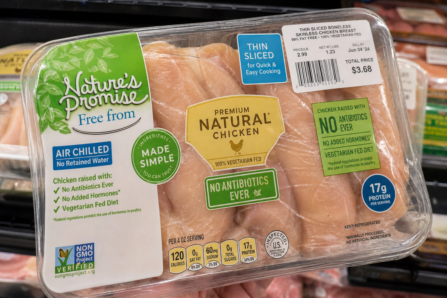 Packaged chicken with multiple colorful marketing labels in grocery store