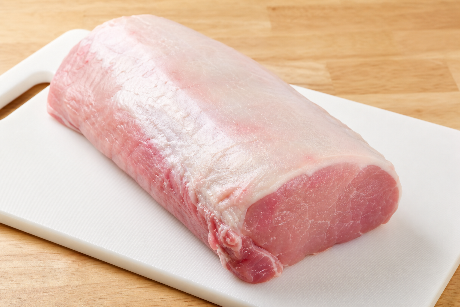 How to Cut a Whole Pork Loin Into Chops, Roasts & More 7 Whole raw pork loin on a white cutting board