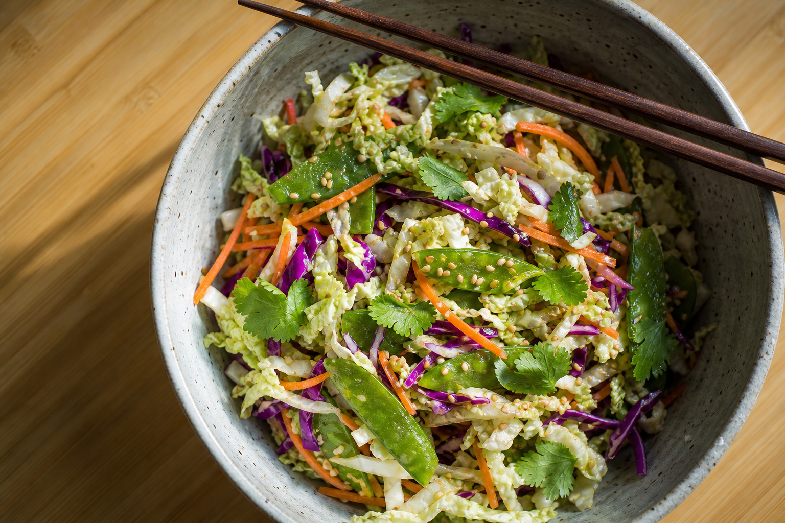 10 Coleslaw Ideas That Go Beyond the Basics 16 Asian vinegar slaw with napa cabbage, snow peas, sesame seeds, and cilantro in a ceramic bowl