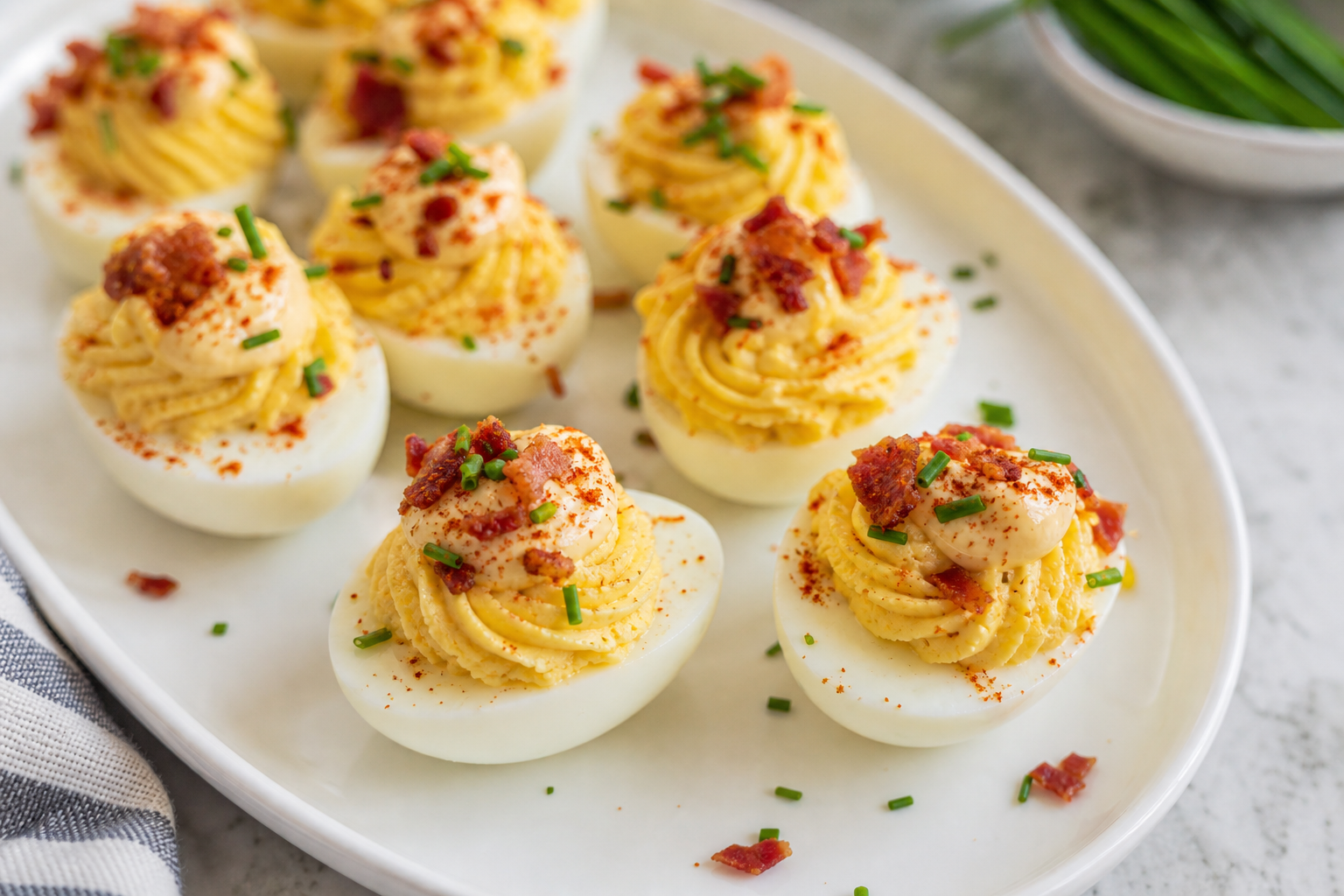 15 Smoker Side Dish Ideas That Pair with Everything 30 Deviled eggs topped with smoked paprika aioli crispy bacon and fresh chives on a white platter